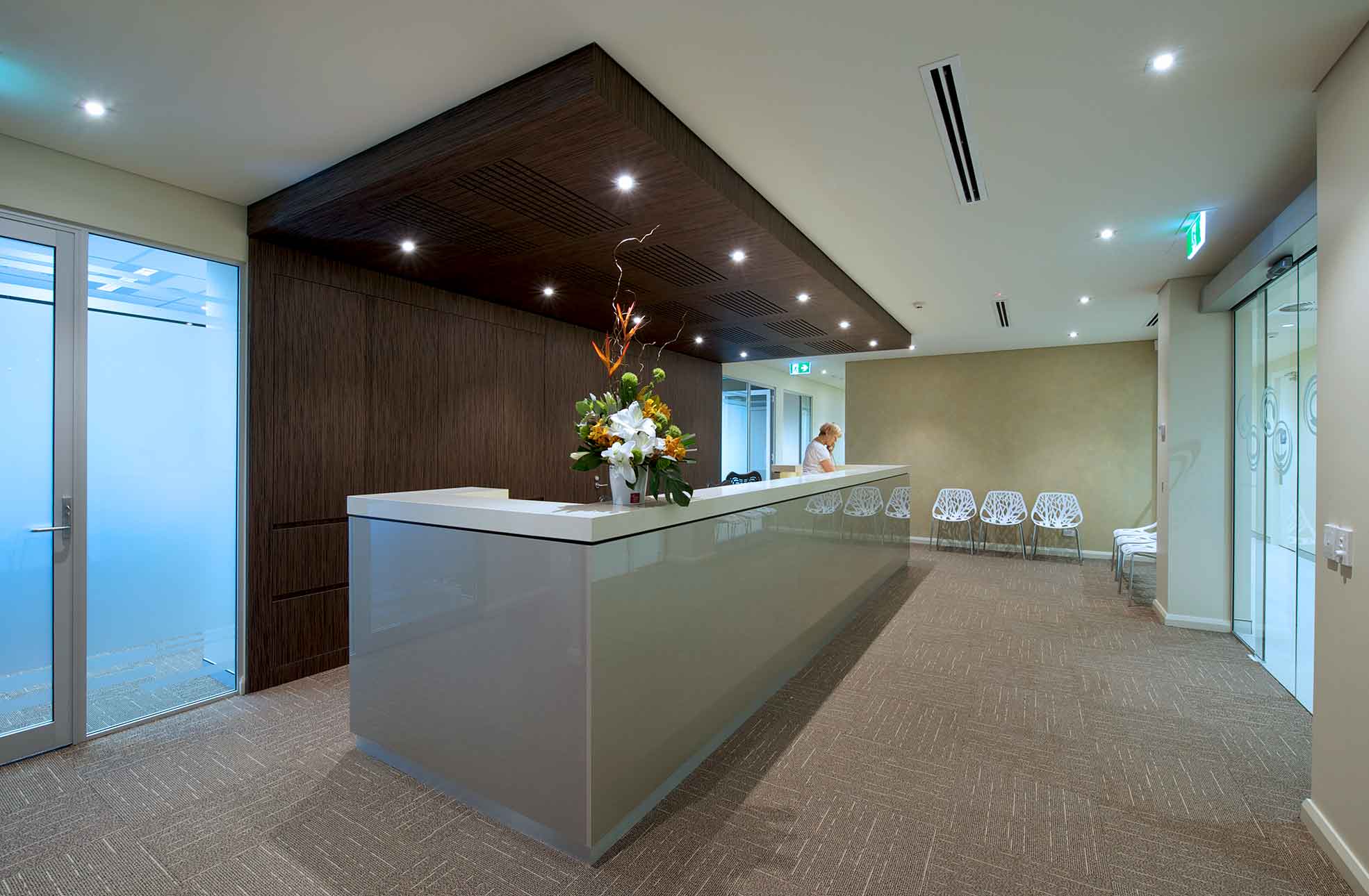 Medical fitout & suite with long white reception desk, waiting room chairs