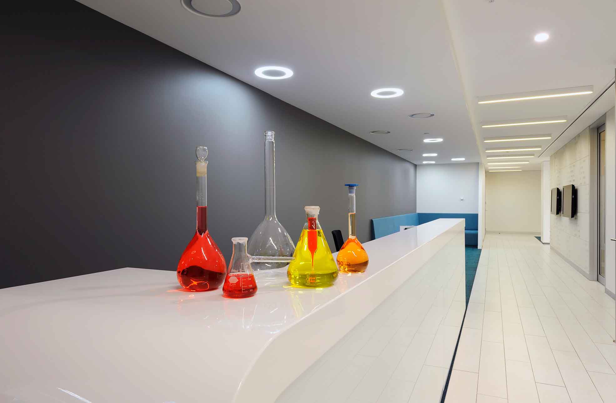 Interior fitout reception desk with laboratory flasks, beakers & coloured liquids inside