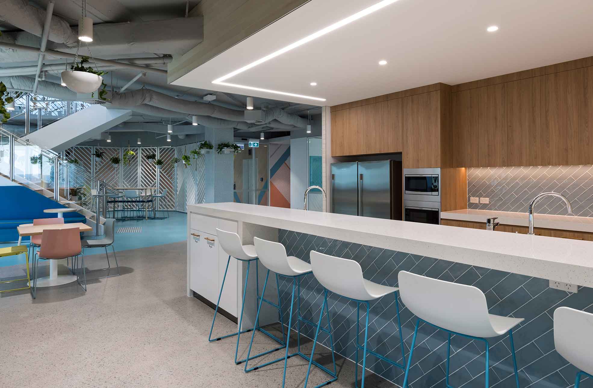 Modern commercial fit out solution kitchen bar, stools, breakout areas, stairs to offices.