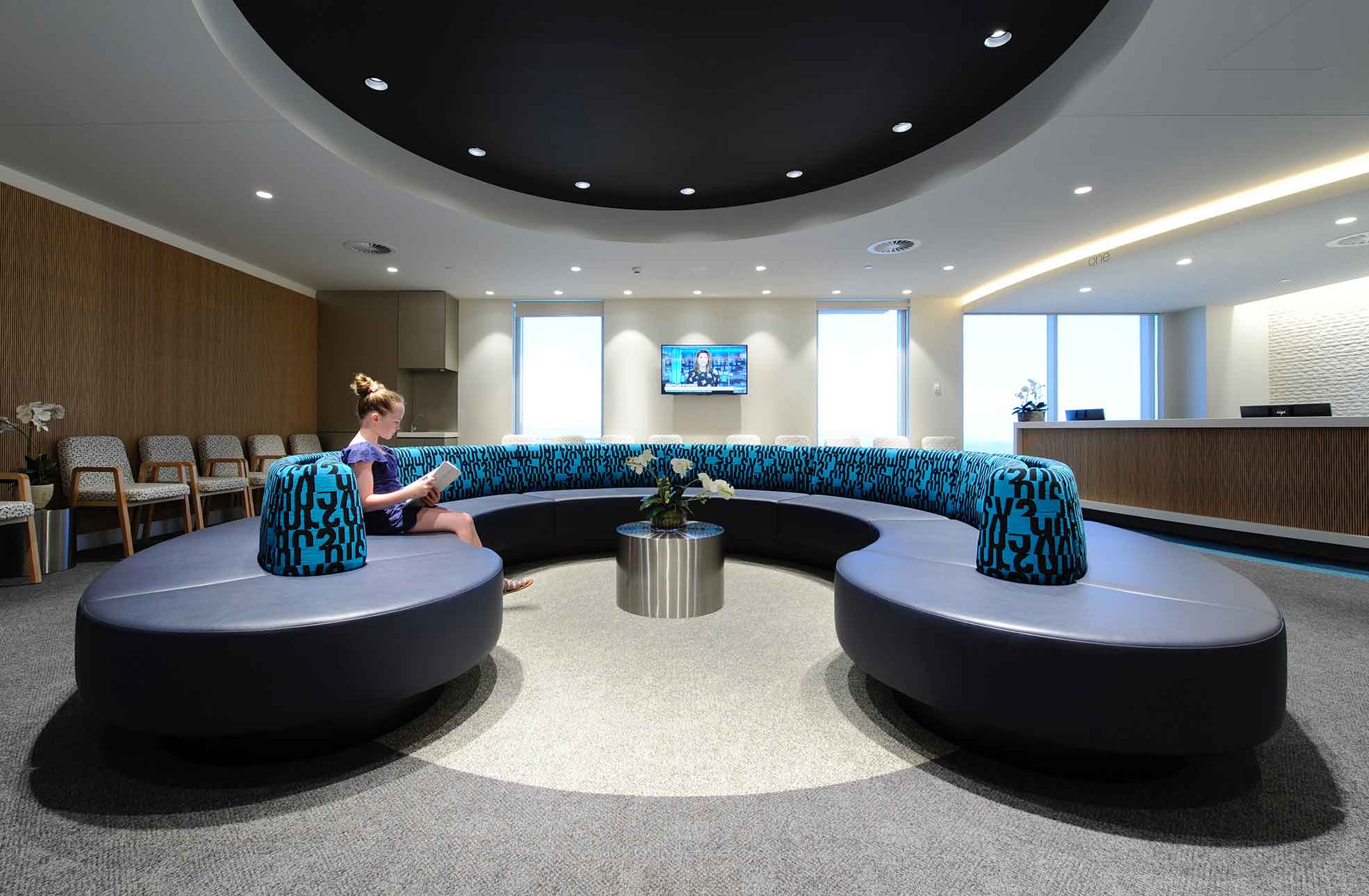 Healthcare fitout reception, modern curved blue patterned lounge