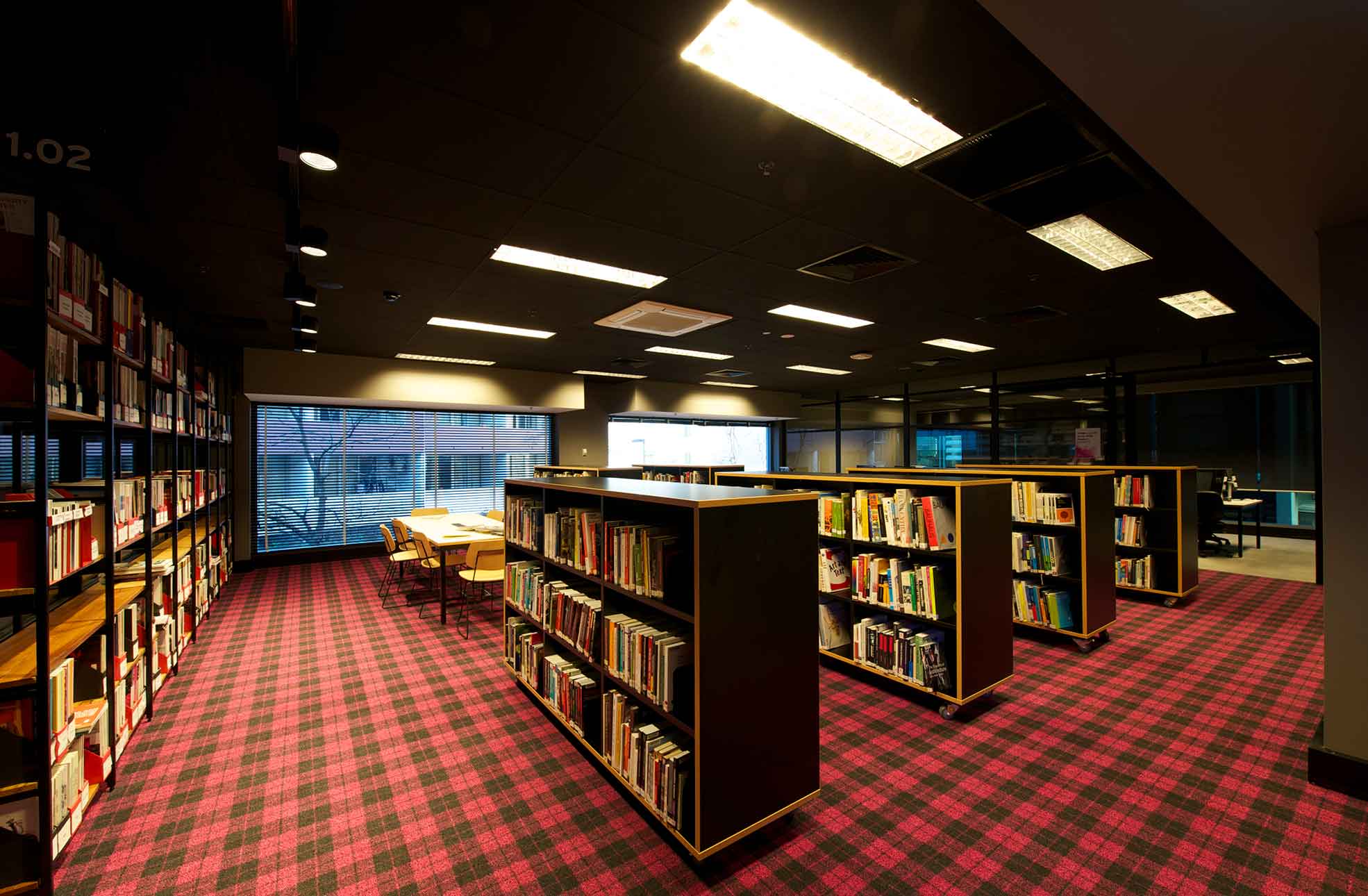 Refurbished fitout of library, rows of books and old world feel in heritage building.